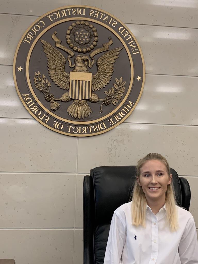 A pre-law student poses for a photo at the U.S. District Court for the Middle District of Florida.